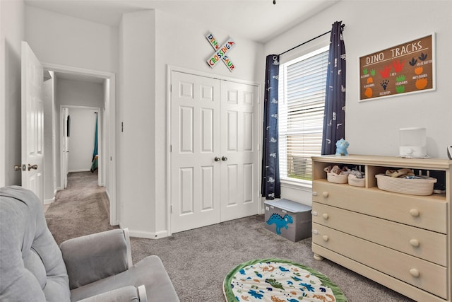 bedroom with baseboards, carpet floors, and a closet