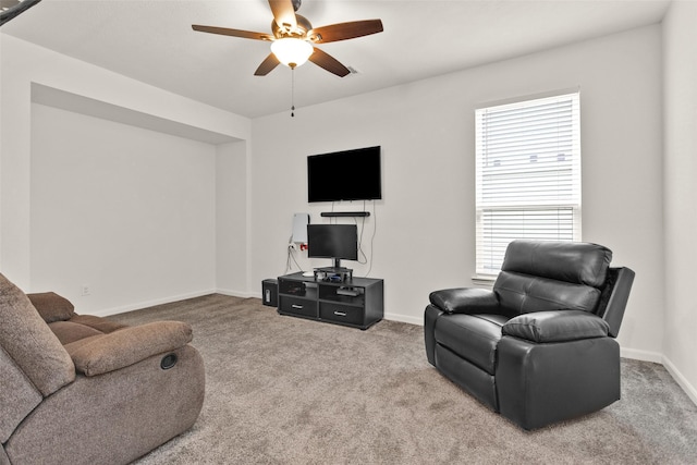 living area with ceiling fan, a wealth of natural light, baseboards, and carpet