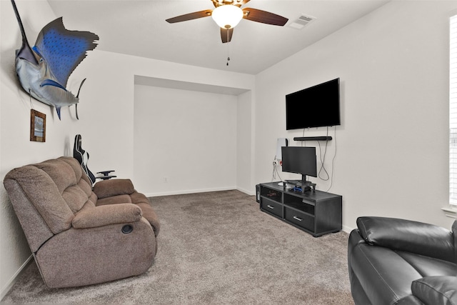 living room featuring carpet floors, visible vents, a ceiling fan, and baseboards