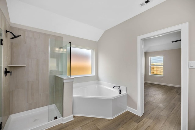 full bathroom with visible vents, a garden tub, wood finished floors, lofted ceiling, and a shower stall