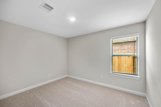 unfurnished room with baseboards, light carpet, recessed lighting, and visible vents