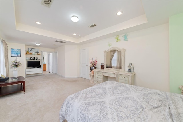 bedroom featuring light colored carpet, a tray ceiling, visible vents, and recessed lighting
