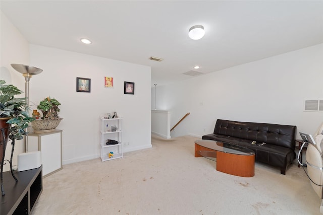 sitting room featuring visible vents, carpet floors, and an upstairs landing