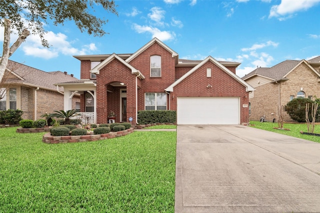 traditional home with brick siding, driveway, a front yard, and a garage