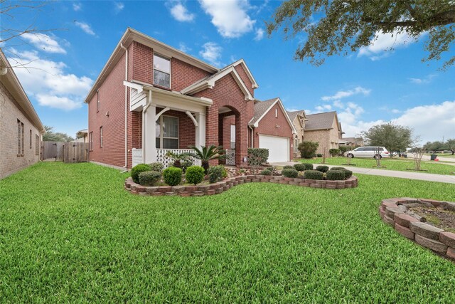 traditional-style home featuring an attached garage, brick siding, and a front yard