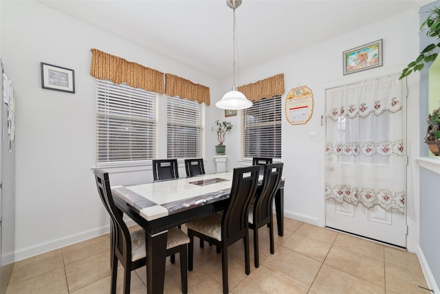dining area with baseboards and light tile patterned floors
