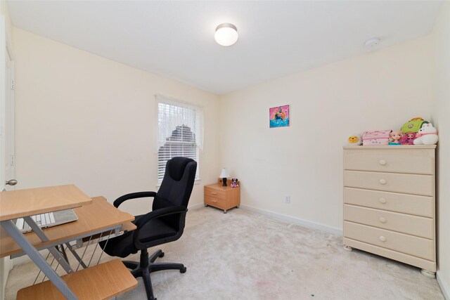 home office featuring light carpet and baseboards