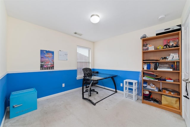carpeted office space with visible vents and baseboards