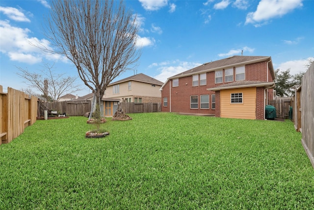 back of property featuring a shed, a lawn, a fenced backyard, an outdoor structure, and brick siding