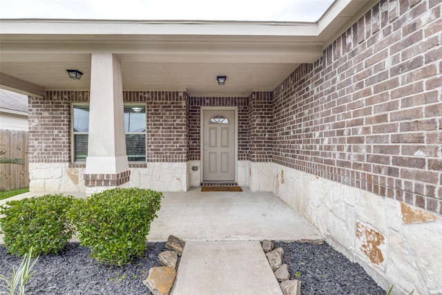 doorway to property featuring brick siding
