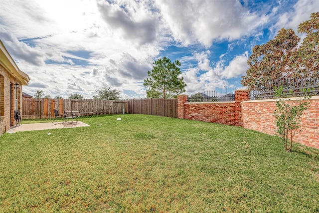 view of yard with fence private yard and a patio