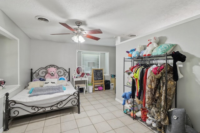 9 Slover Dr, Dayton, TX 77535 - bedroom with light tile patterned flooring, a ceiling fan, a textured ceiling, and visible vents