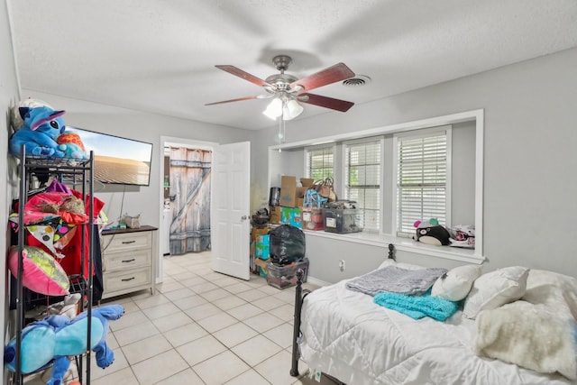9 Slover Dr, Dayton, TX 77535 - bedroom with light tile patterned flooring, a textured ceiling, visible vents, and ceiling fan