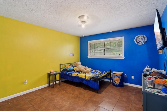9 Slover Dr, Dayton, TX 77535 - bedroom featuring baseboards, tile patterned flooring, and a textured ceiling