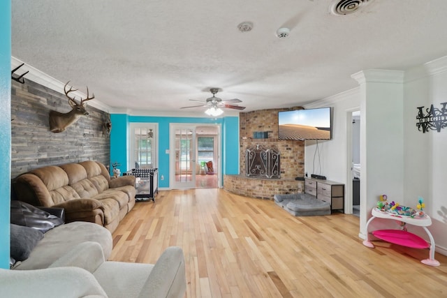 9 Slover Dr, Dayton, TX 77535 - living area with wood finished floors, a textured ceiling, ceiling fan, ornamental molding, and visible vents