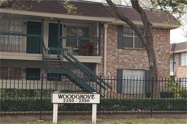 2250 Bering Dr Unit 98, Houston, TX 77057 - view of property with fence, stairway, and a garage