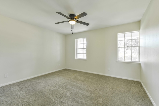carpeted empty room with baseboards and ceiling fan