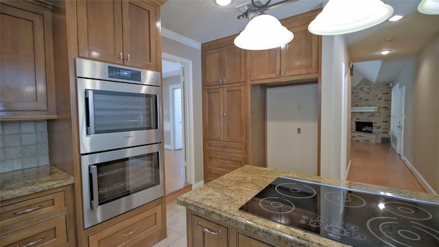 26 Royal Dalton Cir, Conroe, TX 77304 - kitchen featuring brown cabinetry, double oven, and black electric cooktop