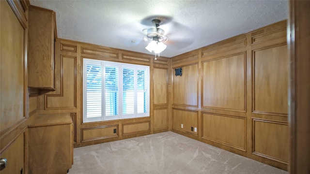 26 Royal Dalton Cir, Conroe, TX 77304 - empty room with a ceiling fan, a textured ceiling, carpet, and a decorative wall