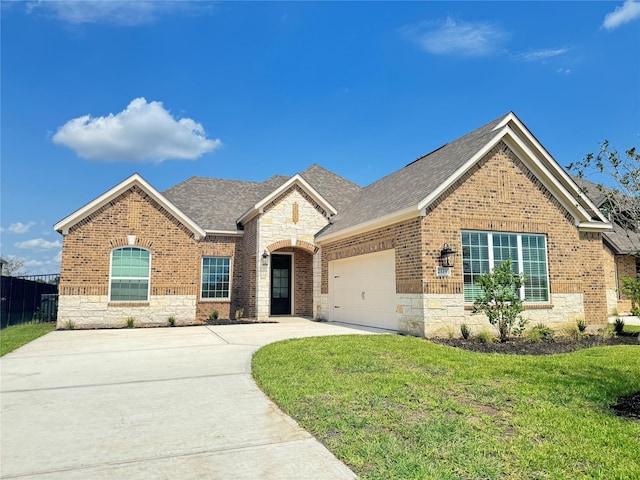 ranch-style home with concrete driveway, brick siding, a garage, and a front yard