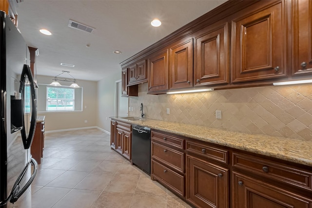 kitchen featuring a sink, decorative backsplash, stainless steel refrigerator with ice dispenser, black dishwasher, and visible vents
