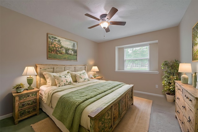 bedroom featuring a ceiling fan, baseboards, and light colored carpet