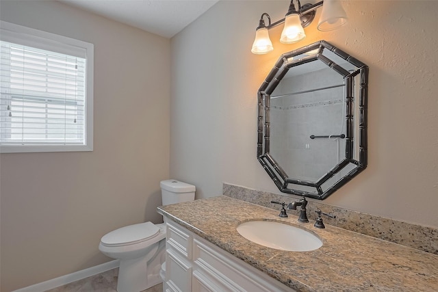 bathroom featuring tile patterned flooring, toilet, vanity, and baseboards
