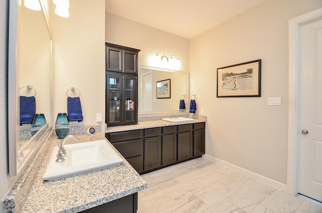 1310 Layla Sage Loop, Richmond, TX 77406 - full bathroom featuring double vanity, baseboards, marble finish floor, and a sink