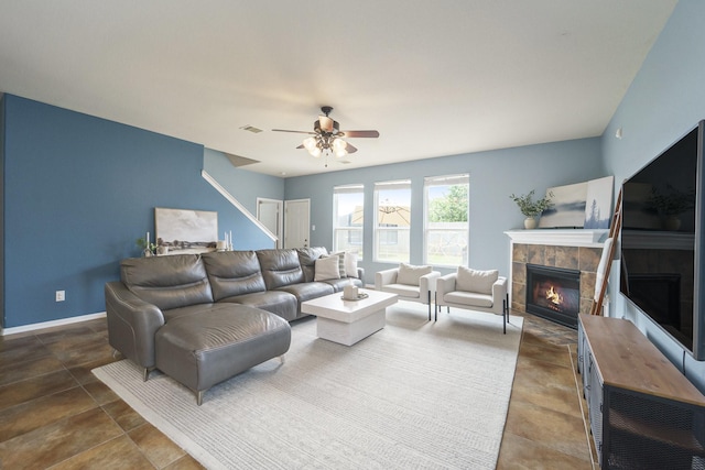 19819 Sloan Ridge Ln, Cypress, TX 77429 - living area featuring a tiled fireplace, ceiling fan, and baseboards