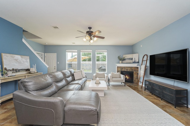 19819 Sloan Ridge Ln, Cypress, TX 77429 - living area with a tile fireplace, ceiling fan, and stairs