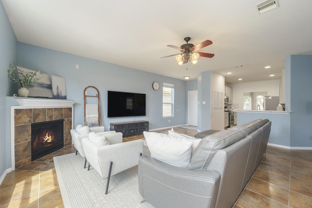 19819 Sloan Ridge Ln, Cypress, TX 77429 - living area featuring a fireplace, a ceiling fan, baseboards, recessed lighting, and tile patterned floors