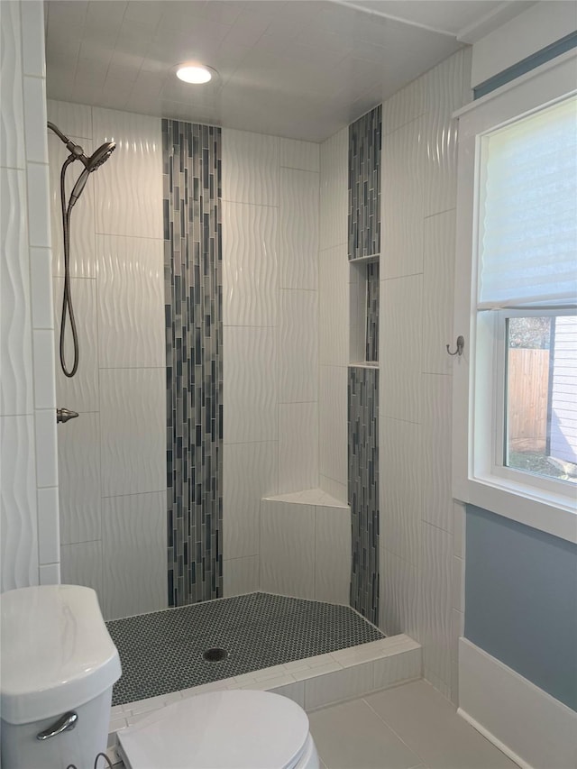 full bath with a tile shower and toilet