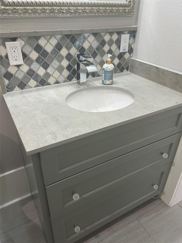 bathroom with tasteful backsplash and vanity