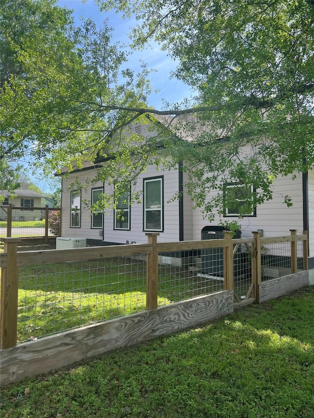 view of home's exterior featuring a yard and a fenced front yard