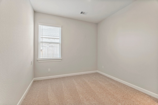 unfurnished room with light carpet, baseboards, and visible vents