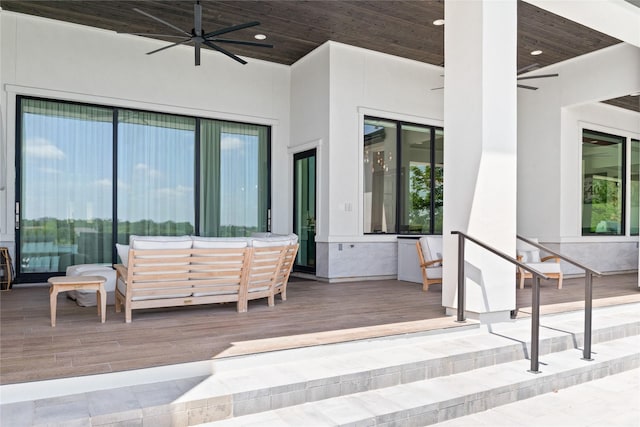 view of patio / terrace featuring a deck, ceiling fan, and an outdoor living space