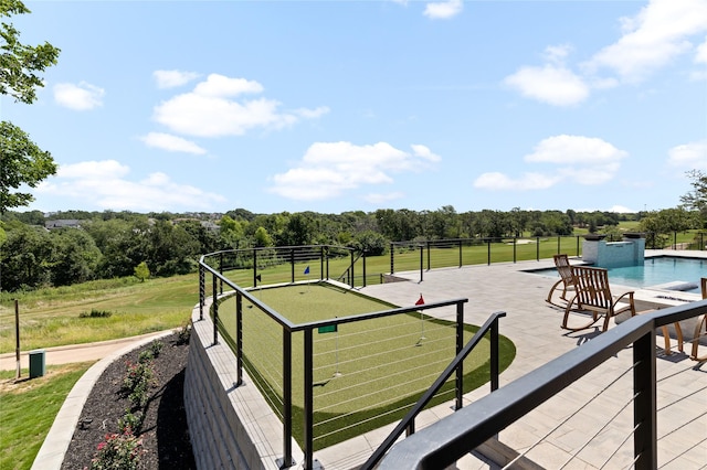 deck with a fenced in pool and a patio area