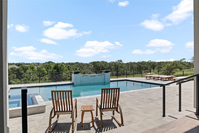 view of swimming pool with a fenced in pool, a hot tub, a patio area, and fence