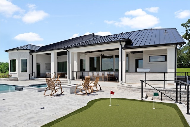 back of house featuring a ceiling fan, a patio area, metal roof, and a standing seam roof