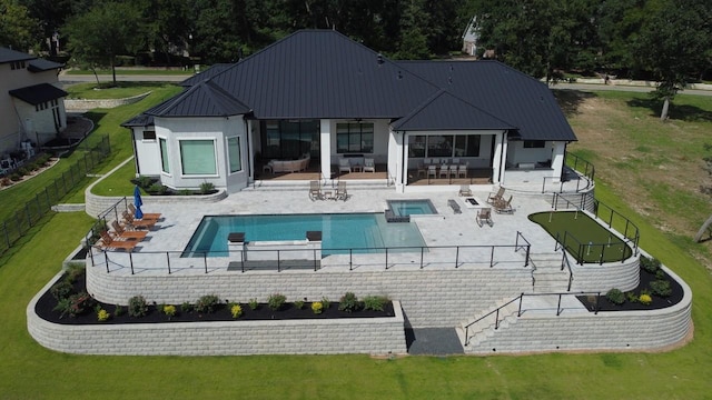 view of swimming pool featuring a fenced backyard, outdoor lounge area, a pool with connected hot tub, and a yard