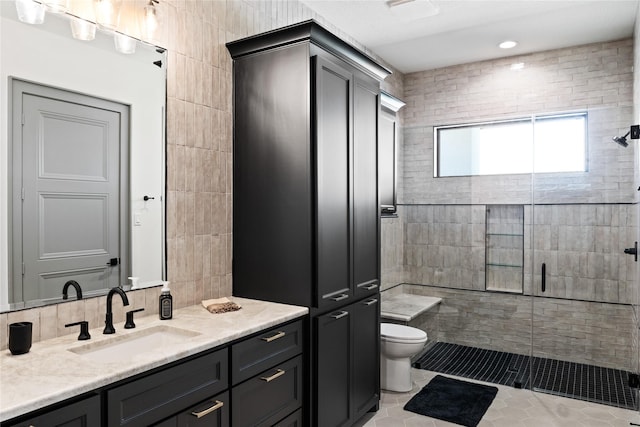 full bath with tile patterned flooring, vanity, toilet, tile walls, and a shower stall