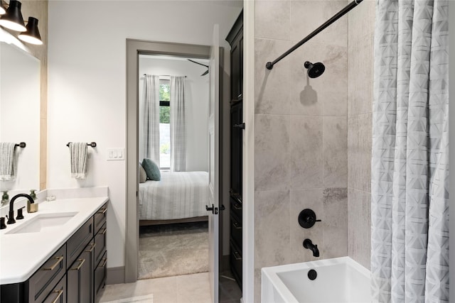 ensuite bathroom with vanity, shower / tub combo with curtain, connected bathroom, and tile patterned flooring