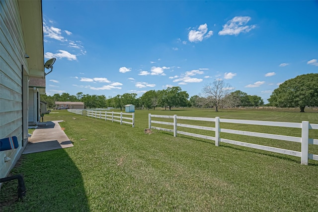 view of yard featuring a rural view and fence