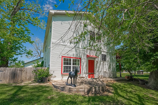 back of house with a patio area, fence, and a yard