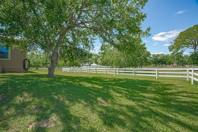 view of yard with central air condition unit and fence