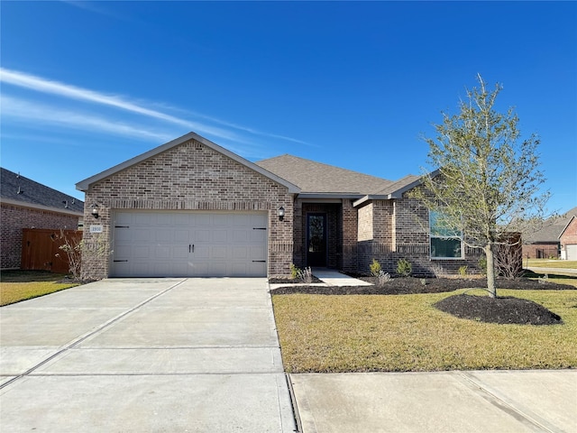 ranch-style house featuring an attached garage, a front lawn, driveway, and brick siding
