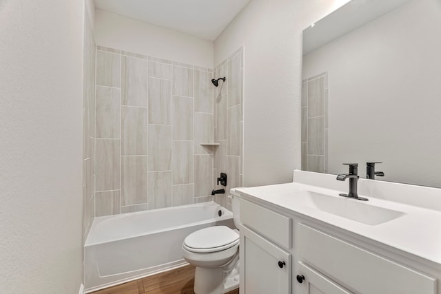 bathroom with toilet, vanity, wood finished floors, and shower / bath combination