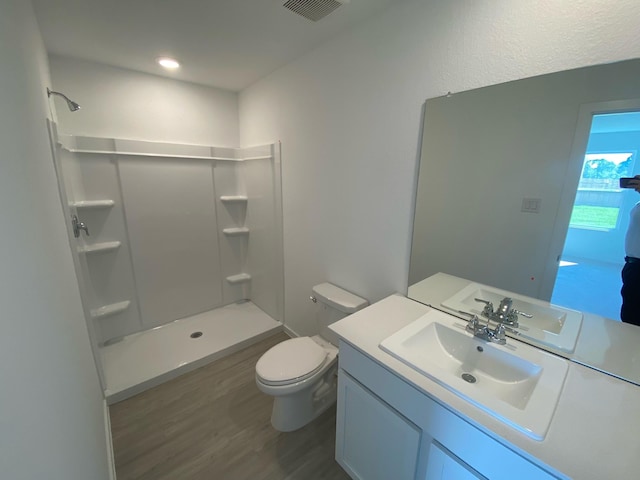 289 Douglas Hills Dr, Magnolia, TX 77354 - bathroom featuring a shower, wood finished floors, toilet, and vanity