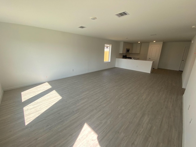 289 Douglas Hills Dr, Magnolia, TX 77354 - unfurnished living room with light wood-style flooring and baseboards
