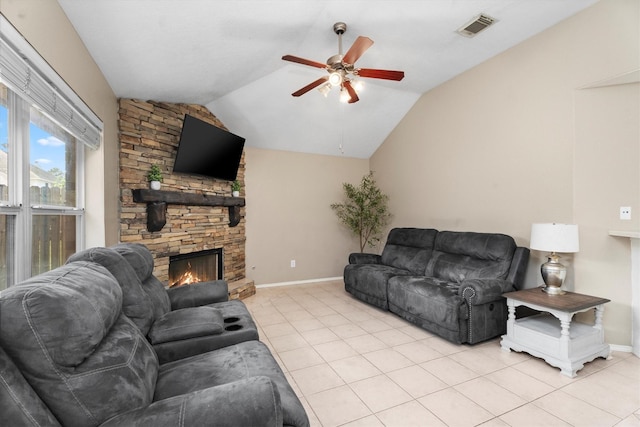 living area with lofted ceiling, visible vents, a ceiling fan, light tile patterned floors, and a fireplace